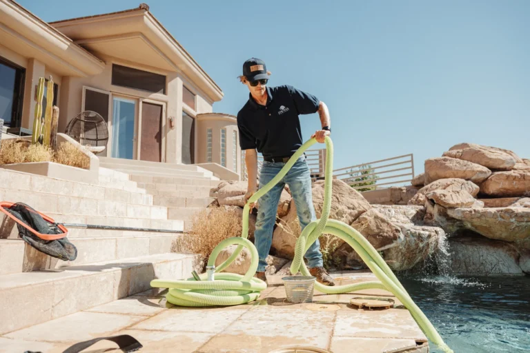 Love Pool Care technician setting up a pool vacuum hose