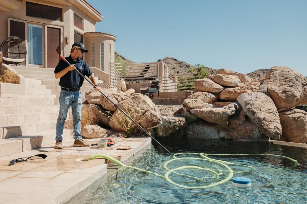 Love Pool Care technician servicing a rock-edged pool