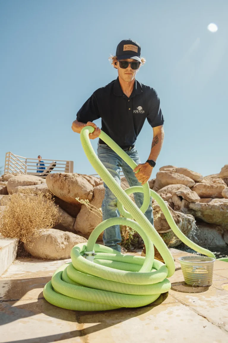 Love Pool Care technician with a pool vacuum hose