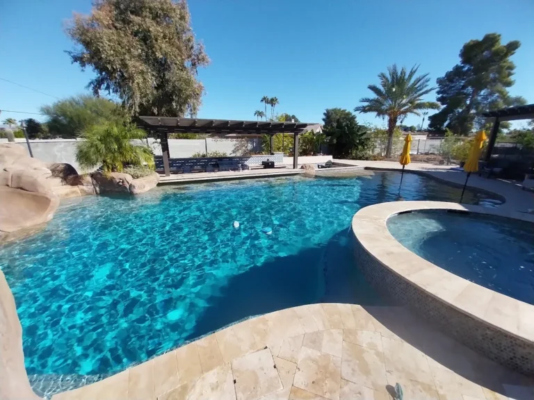 Completed pool remodel surrounded by palm trees